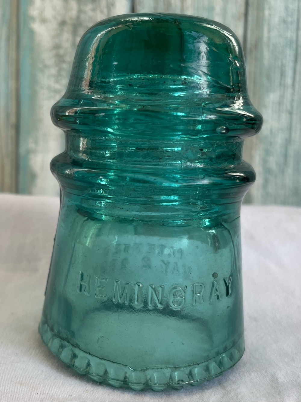 Vintage aqua-blue glass insulator manufactured by the Hemingray Glass Company
